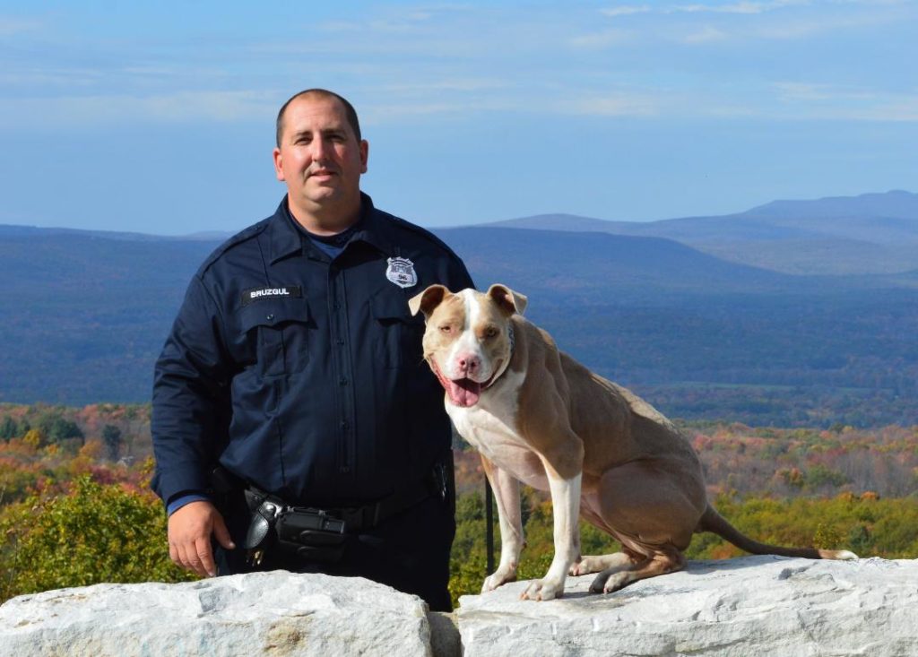 K( Kiah and Officer Justin Bruzgul. Image source: Animal Farm Foundation