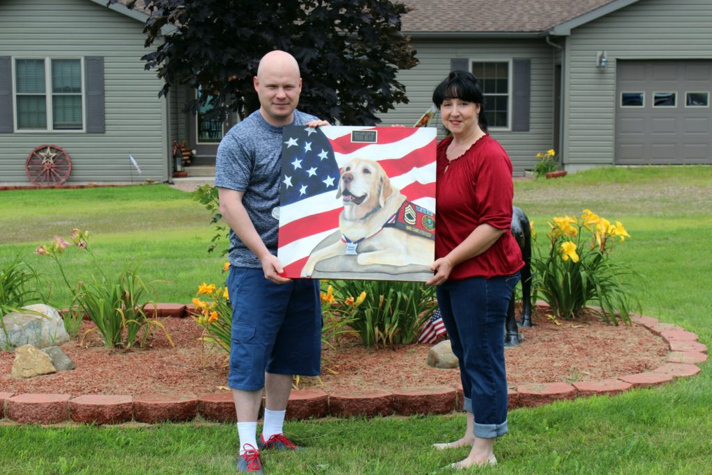 MWD Gabe's photo being giving to Sgt. Shuck. Image source: Loreen Pantaleone