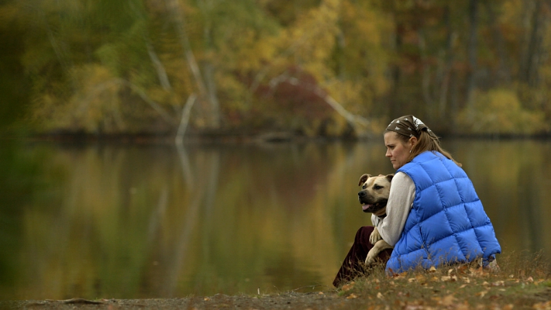 Tranquil at last. Handsome Dan and his pet parent Heather's reflective moment by a lake. Handsome Dan's story is told in "The Champions" is a story about second chances for the dogs rescued from Michael Vick's Bad Newz Kennels, the challenges facing pitbull terrier-type dogs, and the people who advocate for them. Image source: PRNewsFoto/Best Friends Animal Society