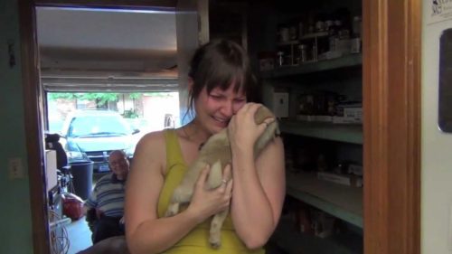 Woman cries over pug puppy