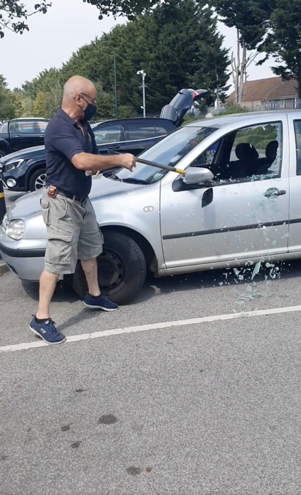 Man Breaks Car Window
