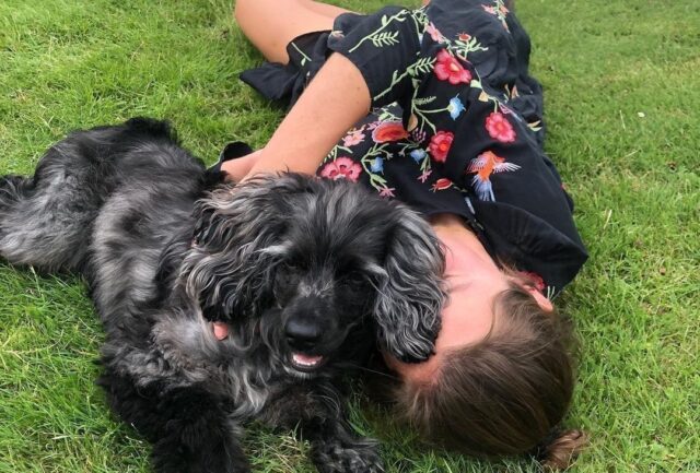 Emma Corrin cuddling dog