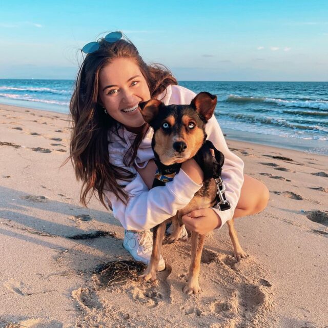 Foster mom hugging foster dog at beach