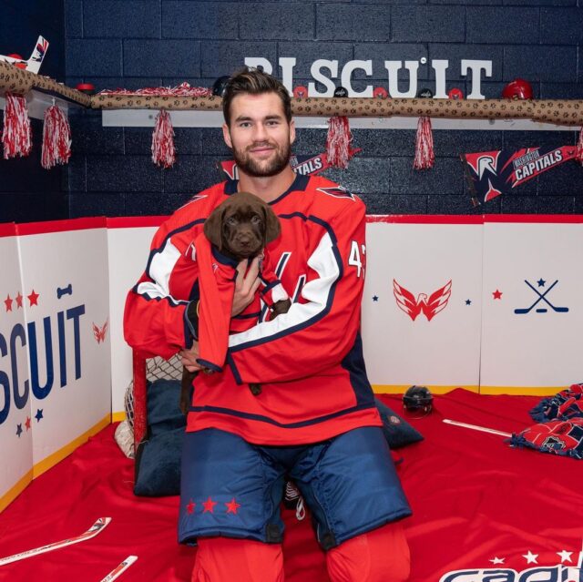 Hockey player and puppy