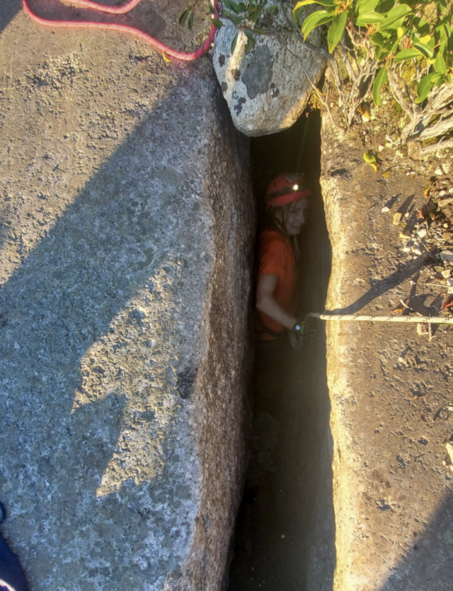 Rescuer in rock crevice