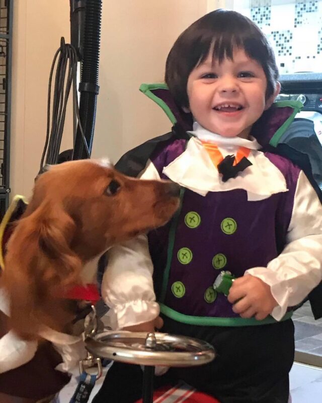 Baby and dog dressed for Halloween