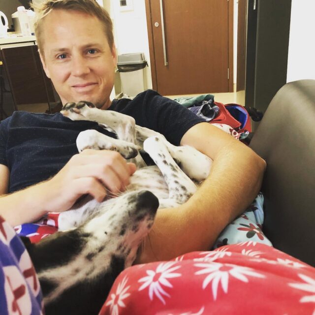 Dog snuggling with her human