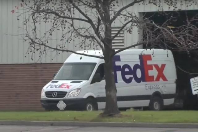 FedEx truck leaving garage