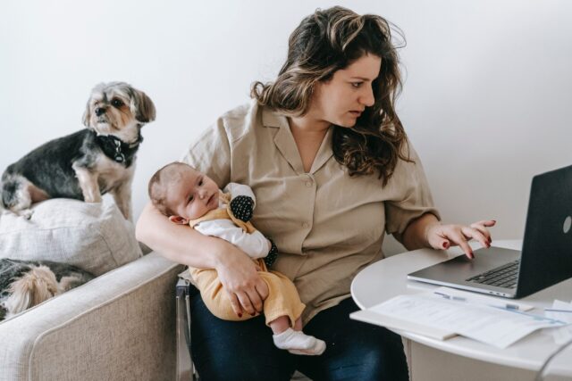 Woman working with baby and dog