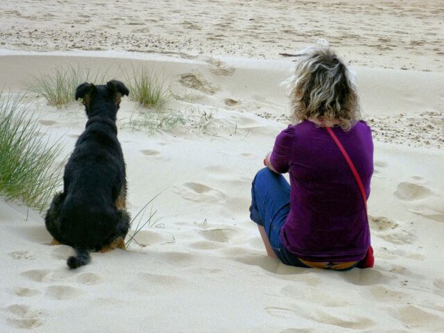  Woman and dog on beach