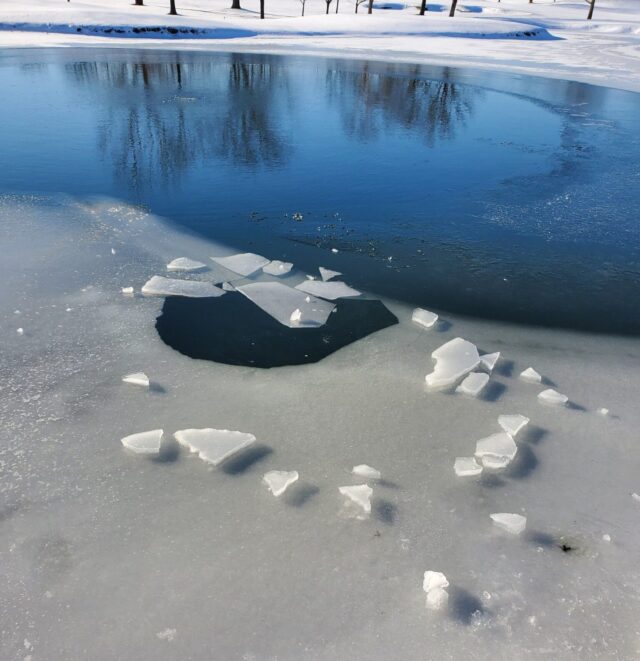 Cracked ice on pond