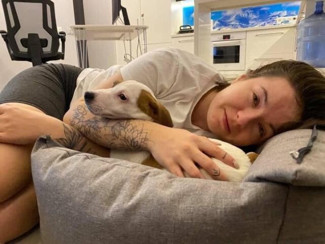 Ukrainian woman cuddling puppy