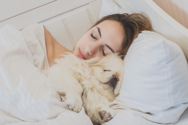 Woman cuddling with dog