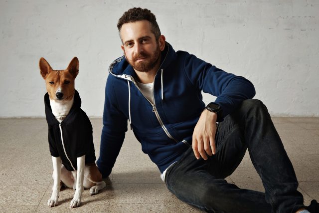 Man and dog with matching sweatshirts