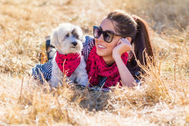 Woman and dog with matching scarfs