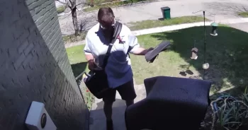 Hulk the dog greeting mail carrier