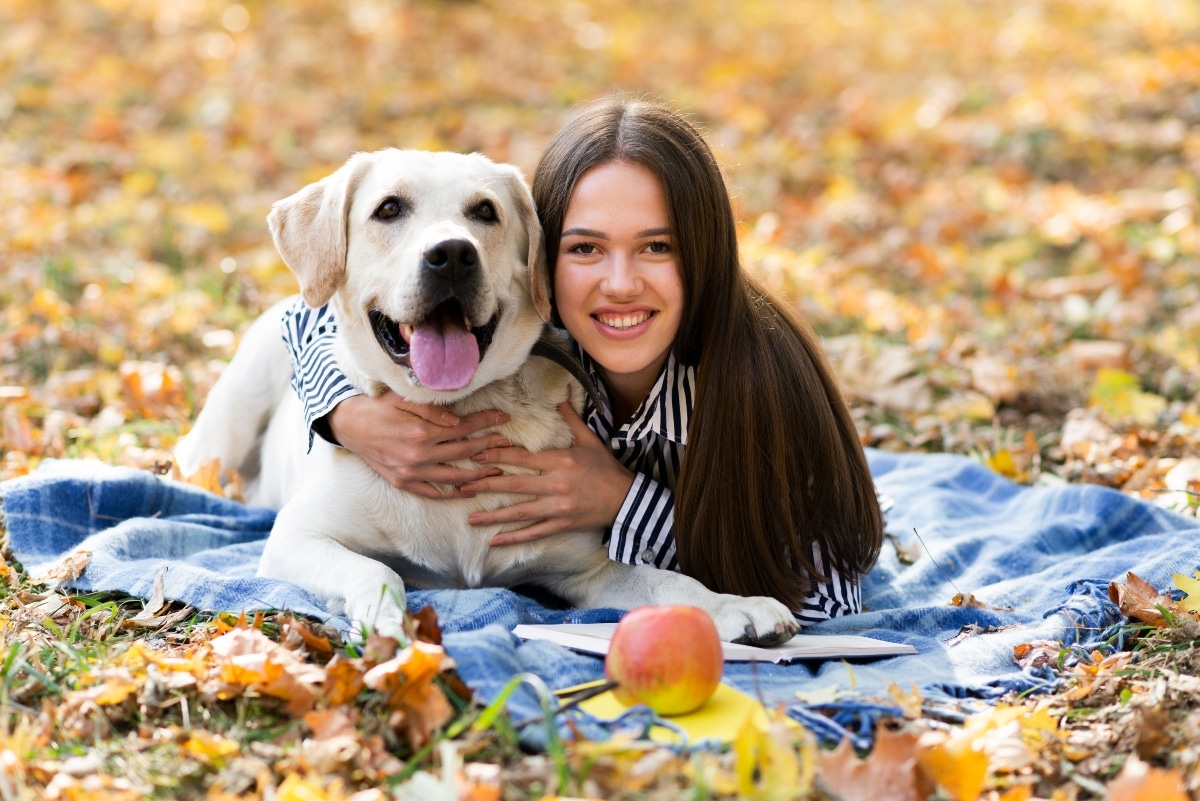 Labrador Retriever snuggling with family members, showcasing its affectionate demeanor.