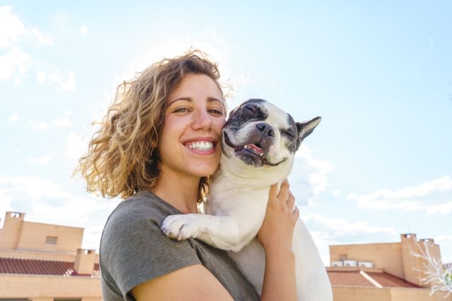 Happy,Woman,Holding,French,Bulldog.,Horizontal,View,Of,Woman,With,Pet