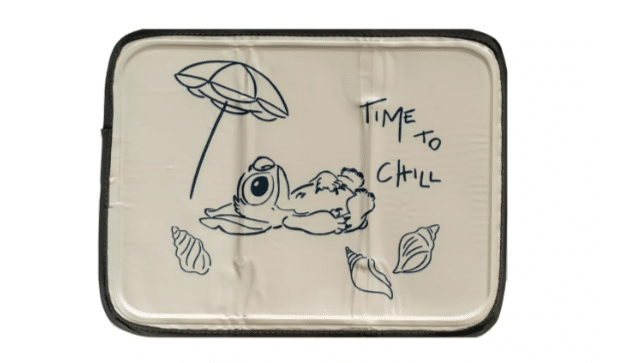 A tan cooling mat featuring Disney's Stitch lying under an umbrella, saying "Time to Chill."