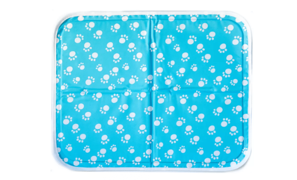 An aqua blue dog cooling mat with white pawprints from PetSmart