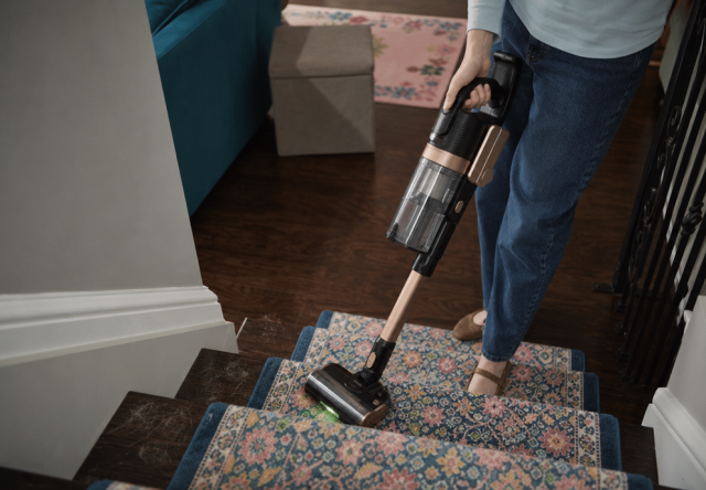 Vacuuming dog hair off a carpeted stair runner with the cordless Levoit VortexIQ Pro