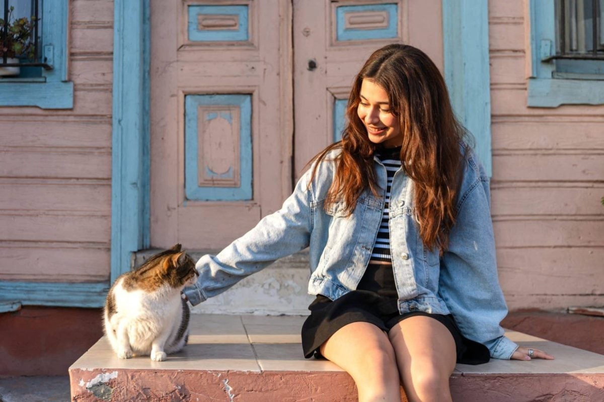 A cat giving a relaxed slow blink while sitting comfortably near their person.
